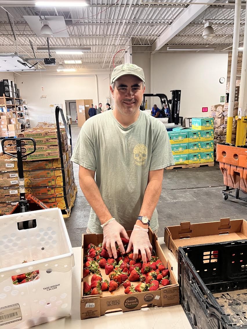 Alex Demopoulos rescuing fresh strawberries for Philo’s Kitchen